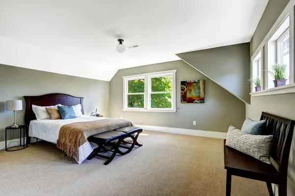 Bedroom with green walls and vaulted ceiling