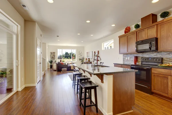 House interior with open floor plan. Kitchen room wiht island