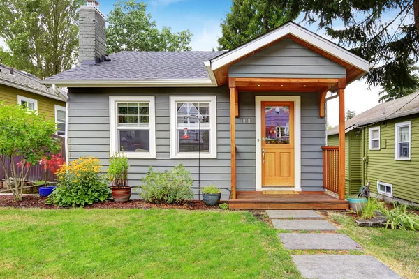 Grey old house with wooden trim