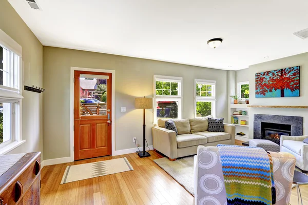 House interior. Living room with fireplace and comfortable sofa