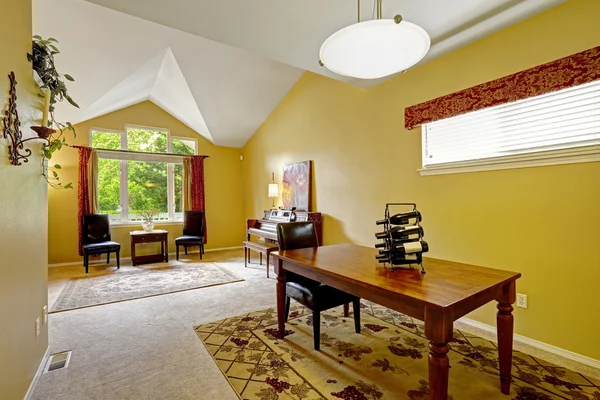 House interior with bright yellow walls and vaulted ceiling