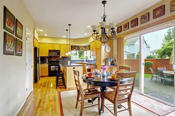 Kitchen with dining area and exit to backyard