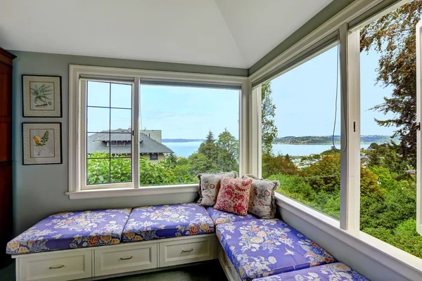 Cozy sitting area in bedroom with bay view