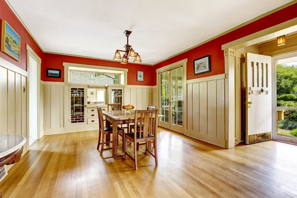 Red and white spacious dining room  with exit to backayrd area