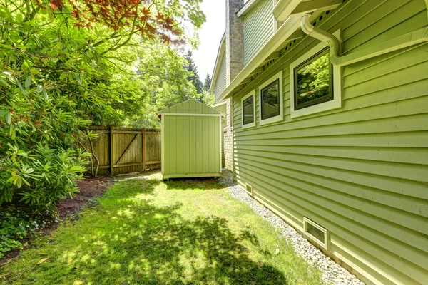 Fenced backyard with small shed