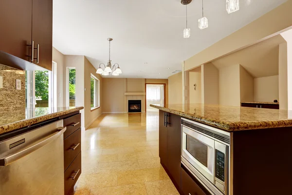 Empty house interior with kitchen area. Marble tile floor