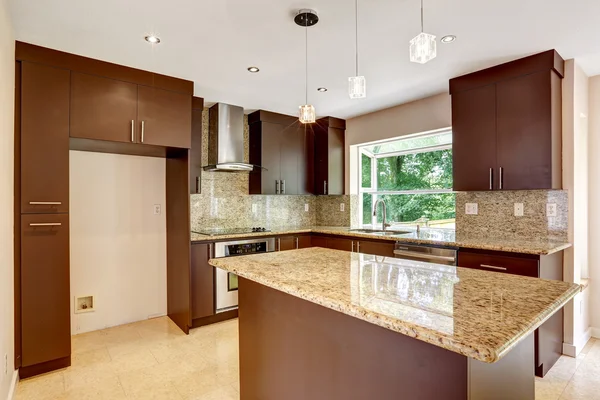 Modern kitchen room with matte brown cabinets and shiny granite