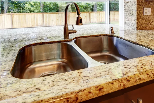 Double steel sink with and granite top. CLose up view