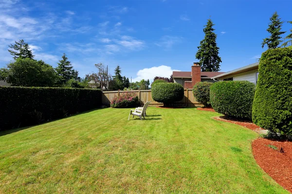 Front yard with sitting area and trimmed hedges