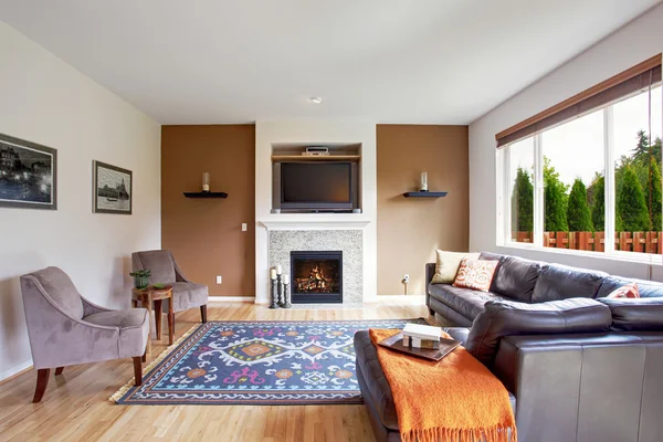 White and brown tone living room with fireplace and tv