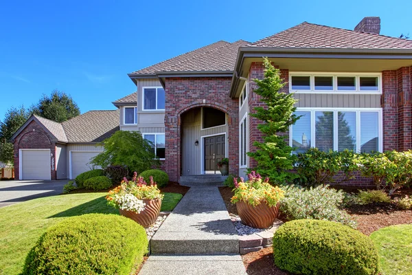 Luxury house with brick wall trim and beautiful curb appeal