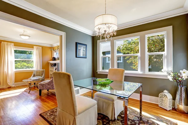 Dining table with glass top and two elegant chairs