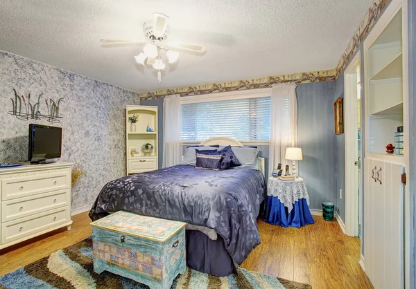 Elegant bedroom with hardwood floors.