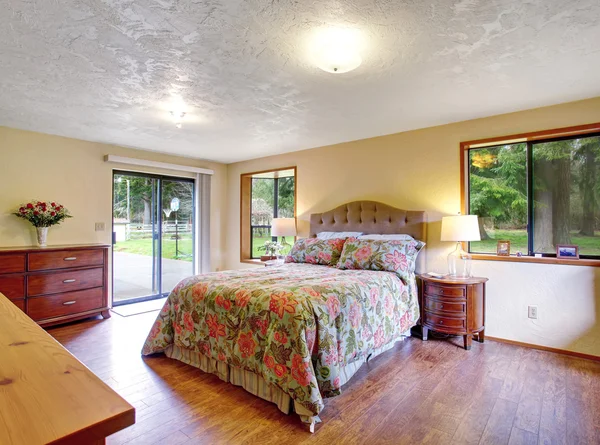 Gorgeous master bedroom with sliding lgass door and hardwood flo