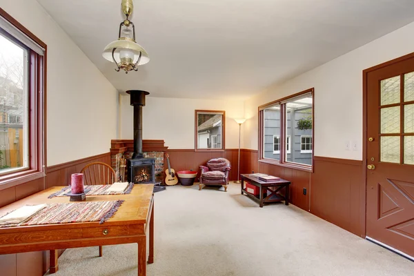 Simple room with fireplace, and chair.