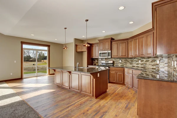 Lovely kitchen with hardwood floor and bar island.
