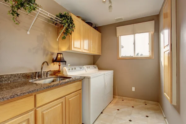 Traditional laundry room with nice counters and washer dryer com