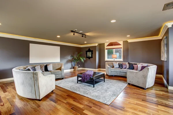 Large home theater living room with gray sofas.