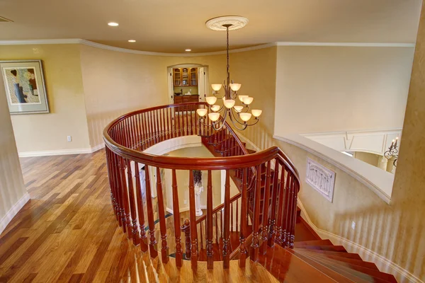 Elegant double staircase with a chandelier.