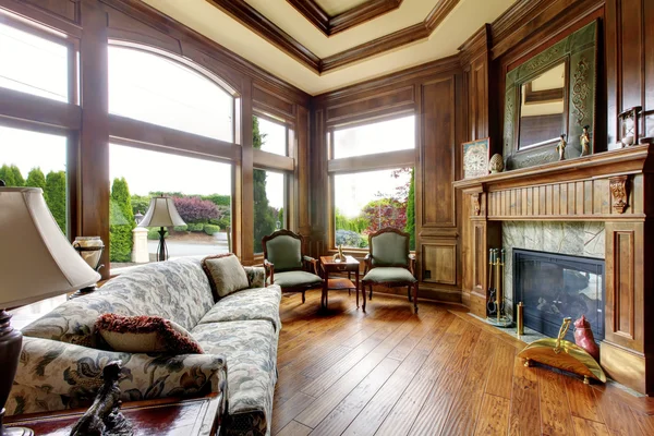 Large luxury living room with big windows.