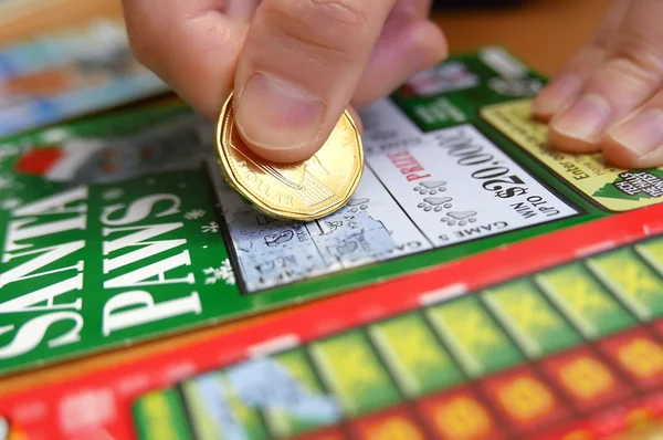Woman scratching lottery tickets.