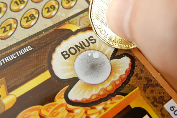 Close up woman scratching lottery ticket