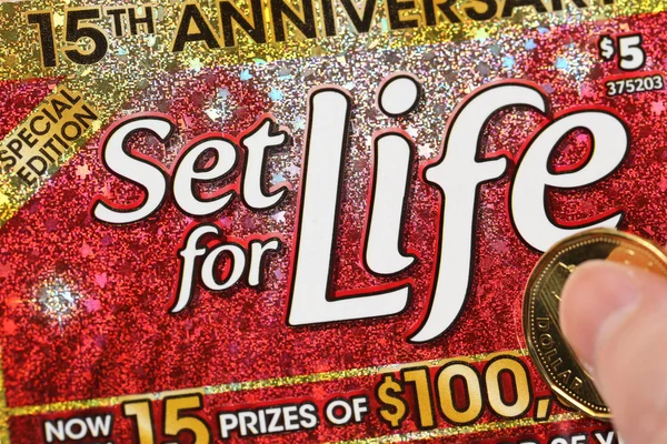 Close up woman scratching lottery ticket called set for life