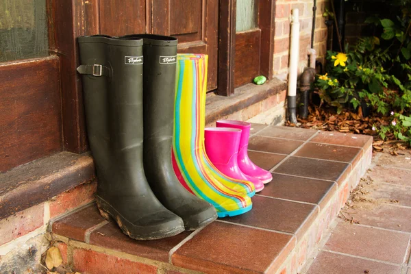 Colourful wellington boots left on a doorstep