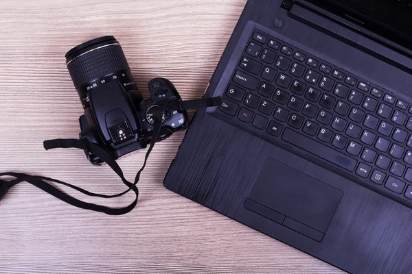 Lay flat image of a laptop and camera