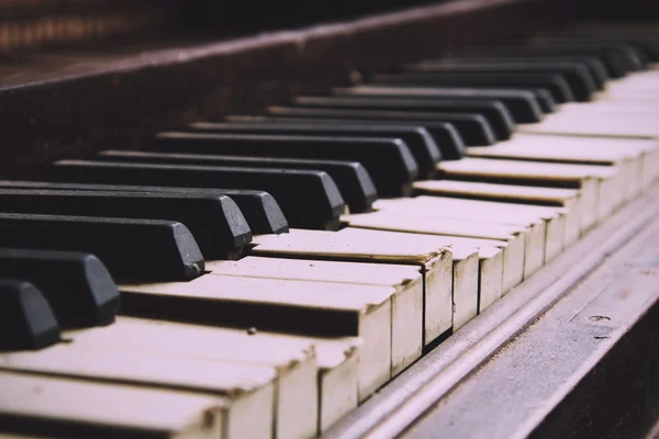 Old broken disused piano with damaged keys Vintage Retro Filter.