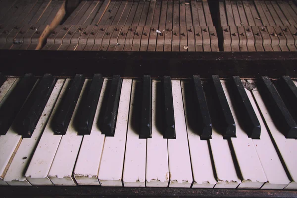 Old broken disused piano with damaged keys Vintage Retro Filter.