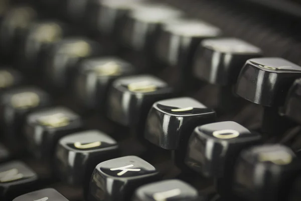 Close up of lettered keys on an old typewriter. Vintage filter a