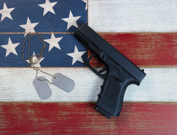 Pistol and ID tags with USA national flag colors painted on fade