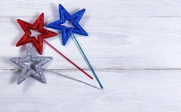 Holiday stars on white wooden boards