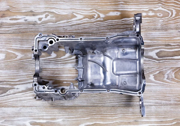 Defected aluminum car engine oil pan with cracks