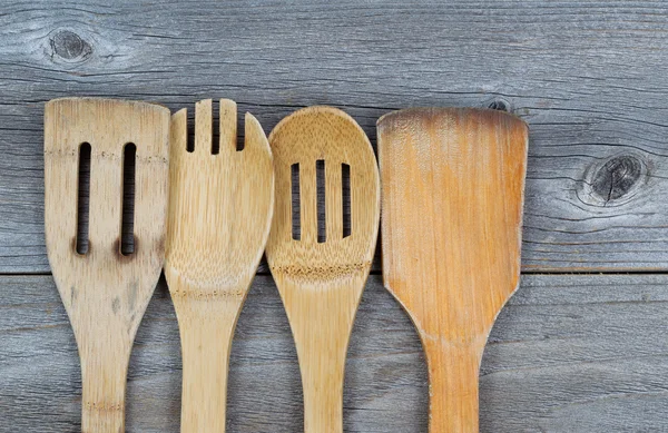 Traditional Wooden Cooking Utensils on Aged Wood