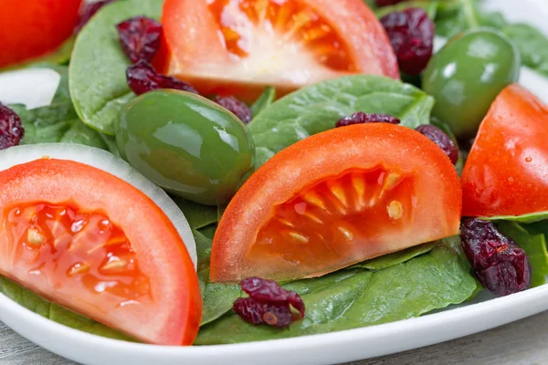 Close up of Fresh Spinach Salad on White Plate