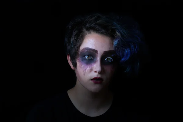 Girl in scary makeup on black background