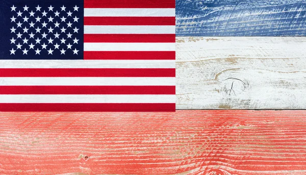 American flag with national colors painted on fading wooden boar