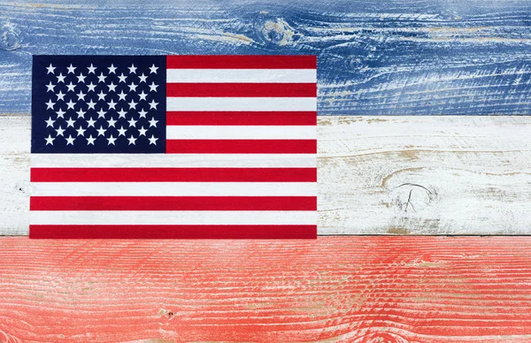 USA flag with national colors painted on fading wooden boards