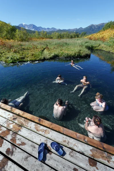 Group of people relaxing in pool with natural thermal mineral water