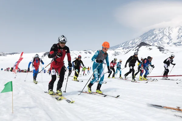 Mass start race, ski mountaineers climb on skis on mountain. Team Race ski mountaineering. Kamchatka, Russian