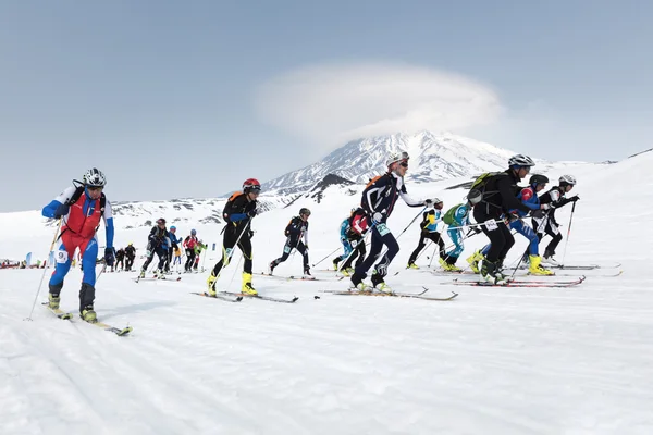 Mass start race, ski mountaineers climb on skis on mountain. Team Race ski mountaineering. Russian, Kamchatka