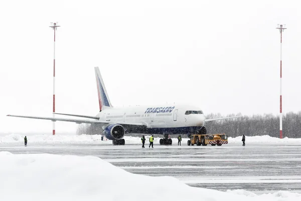 Airdrome trucks pulling Boeing-767 Transaero Airlines at airport of Petropavlovsk-Kamchatsky (Yelizovo airport). Kamchatka, Russia