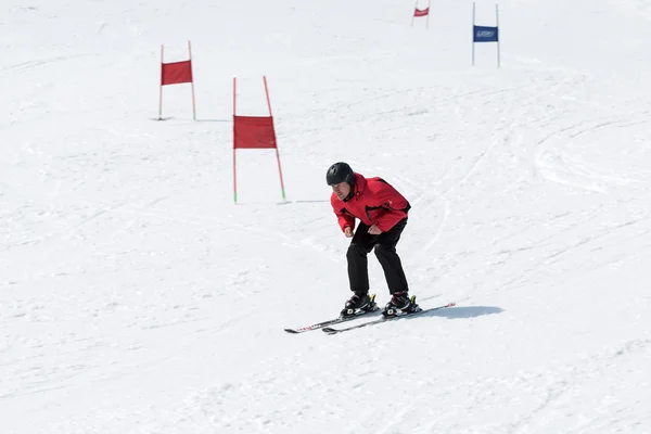 Skier without ski sticks coming down the slope