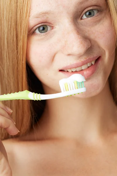 Woman brushing teeth