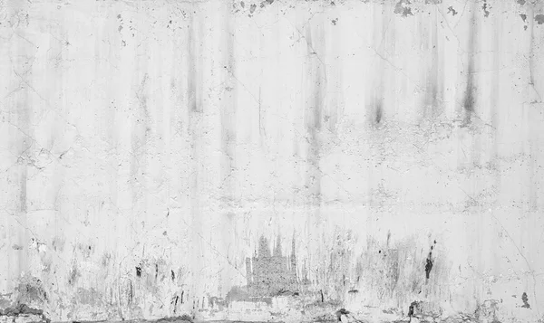 Grungy white concrete wall with traces of plaster