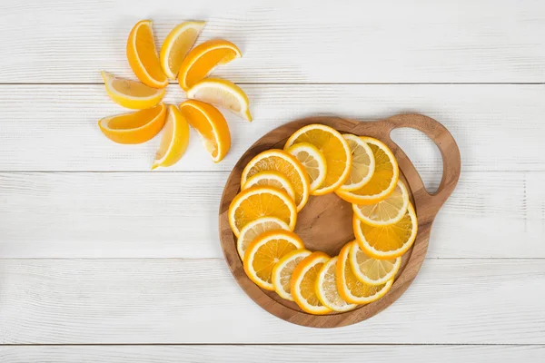 Orange slices are well decorated on a cutting board.