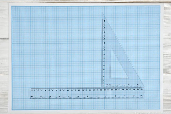 Triangle and simple centimeter ruler on a blueprint.