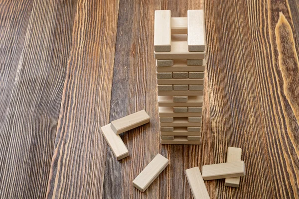 The tower of wooden blocks placed on a table.